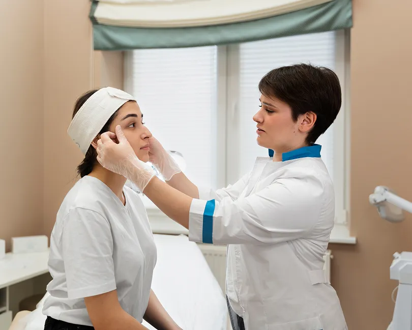A dermatologist talking with a patient in a bright consulting room